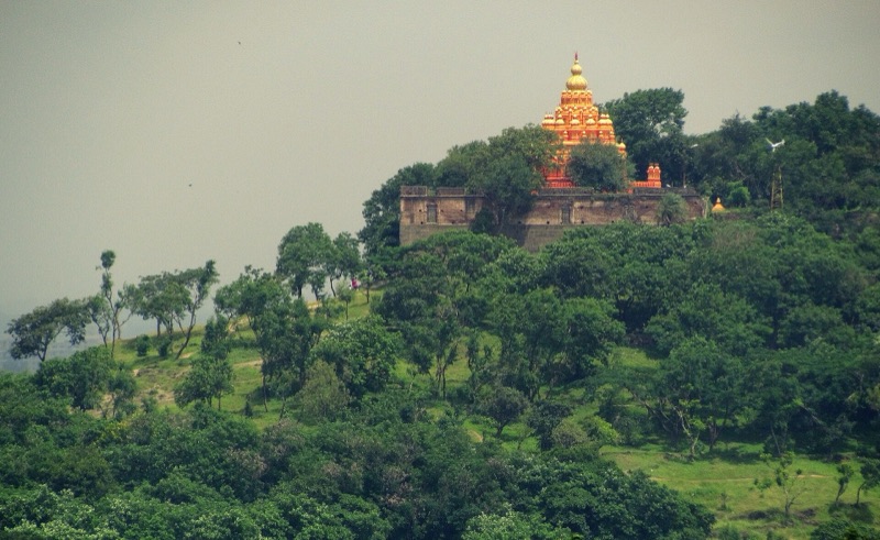 Parvati Hill temple rising above green trees in Pune, India