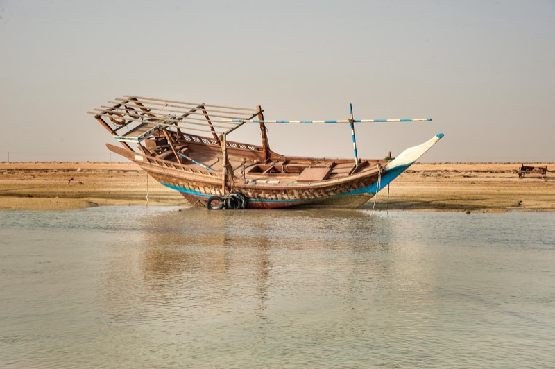 Traditional dhow at low tide on Al Mafjar beach, northern Qatar
