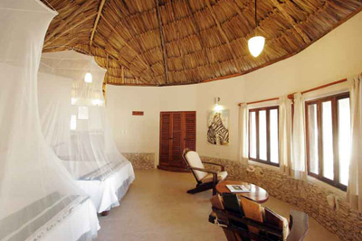 beautifully decorated room with thatched roof